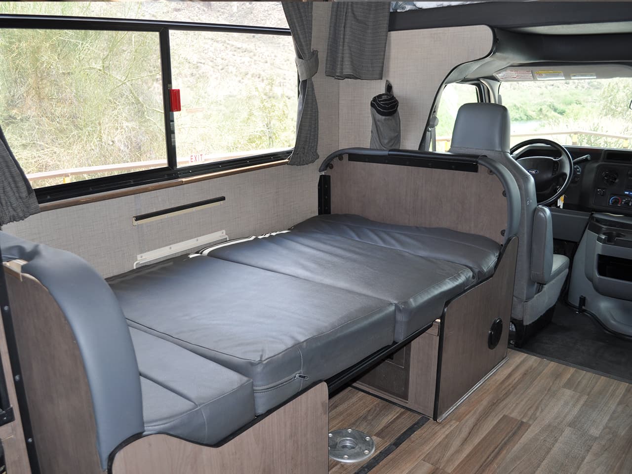 Dining area converted to bed behind driver's seat